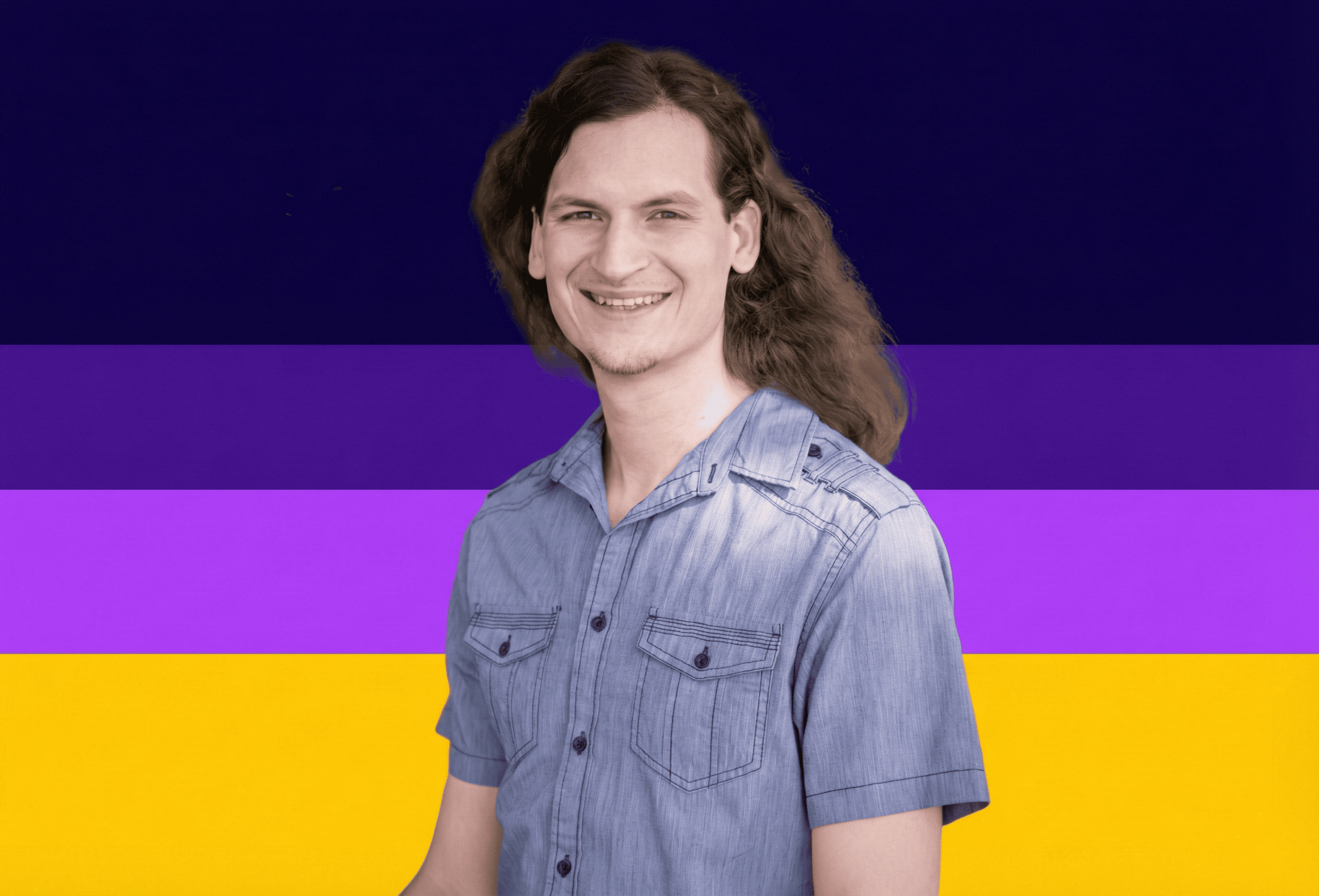 Pol-with-color-background A smiling man with long, wavy hair standing against a vibrant, colorful background.